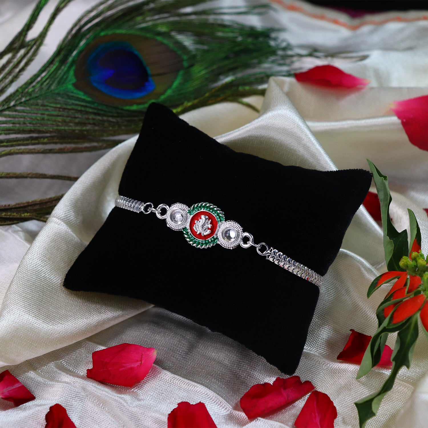 Shiny Silver Rakhi With Ganesha Emblem And Elegant Dual Chain Design Shiny Silver Rakhi With Ganesha Emblem And Elegant Dual Chain Design